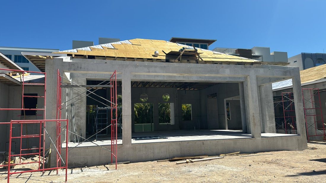 Multi unit concrete building with roof decking going on.